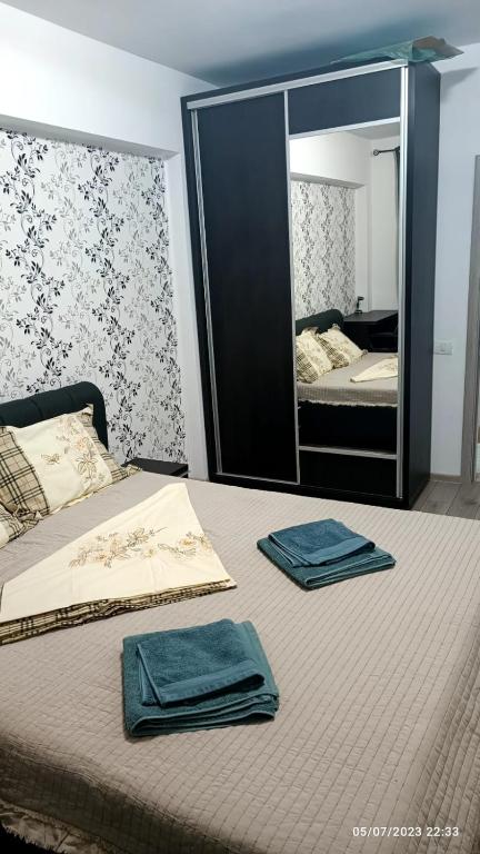 a bedroom with a bed with two towels on it at Natural House in Constanţa