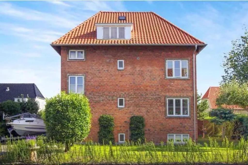 a brick house with a red roof at Close to Centrum, beach and subway in Copenhagen