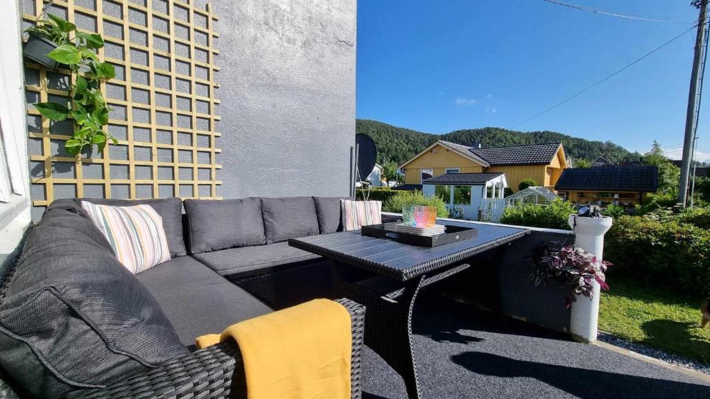 d'un canapé et d'une table sur une terrasse. dans l'établissement Aalesund Holiday Home 4 Bedroom, à Ålesund