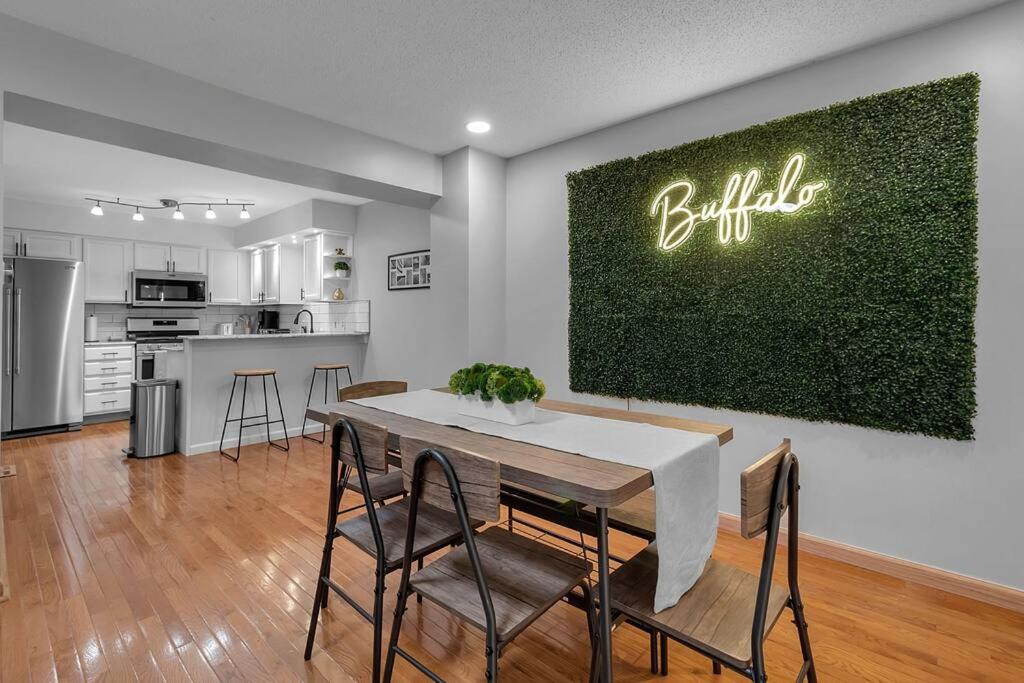 a kitchen and dining room with a table and chairs at Modern Trendy Downtown in Buffalo