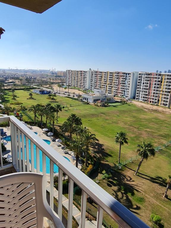a balcony with a view of a park and buildings at ستوديو جولف بورتو مارينا in El Alamein