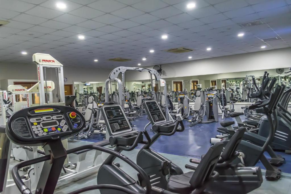 a gym with rows of treadmills and machines at Aktea Beach Village in Ayia Napa