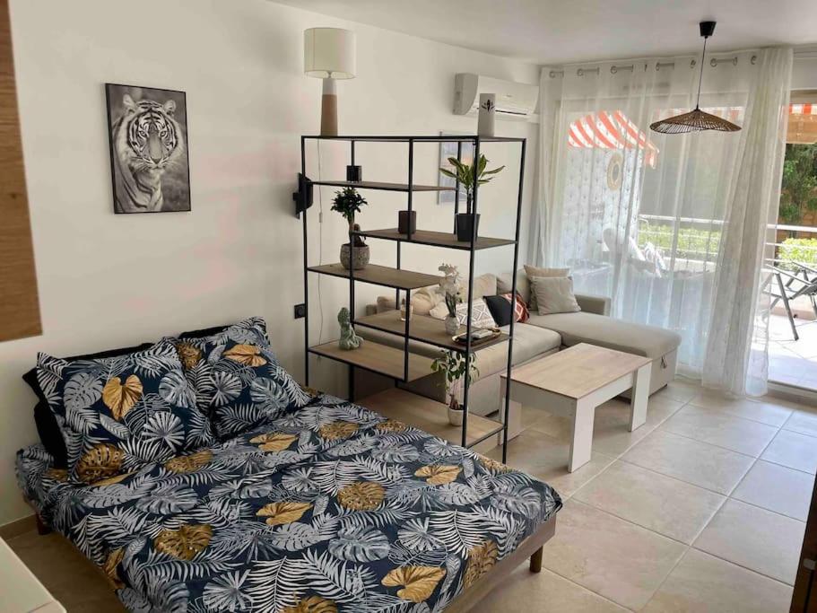 a living room with a bed and a couch at Studio avec terrasse au centre de Saint-Tropez in Saint-Tropez