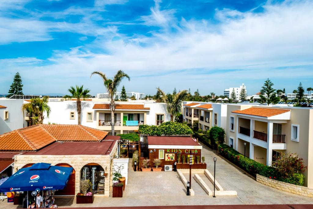 an aerial view of a building with palm trees at Aktea Beach Village in Ayia Napa