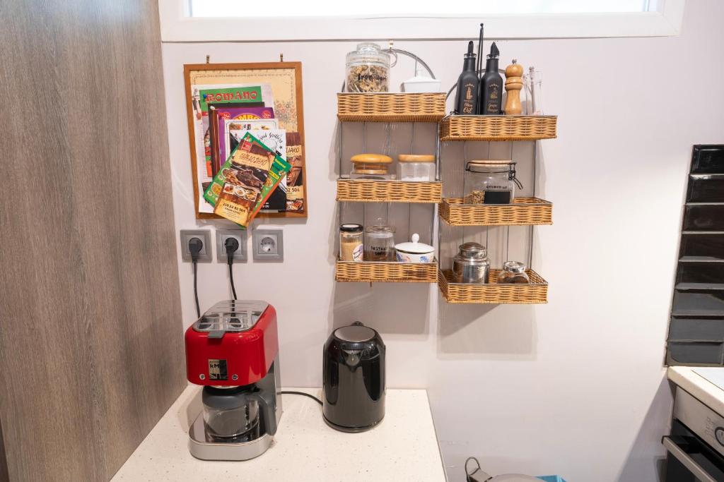 a kitchen with a counter with a coffee maker and baskets at Angel Apartment in Athens