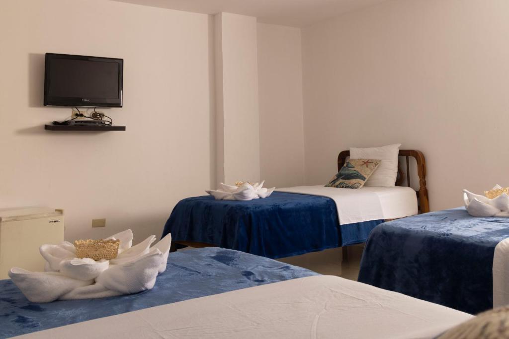 Postel nebo postele na pokoji v ubytování Galapagos Planet Hotel