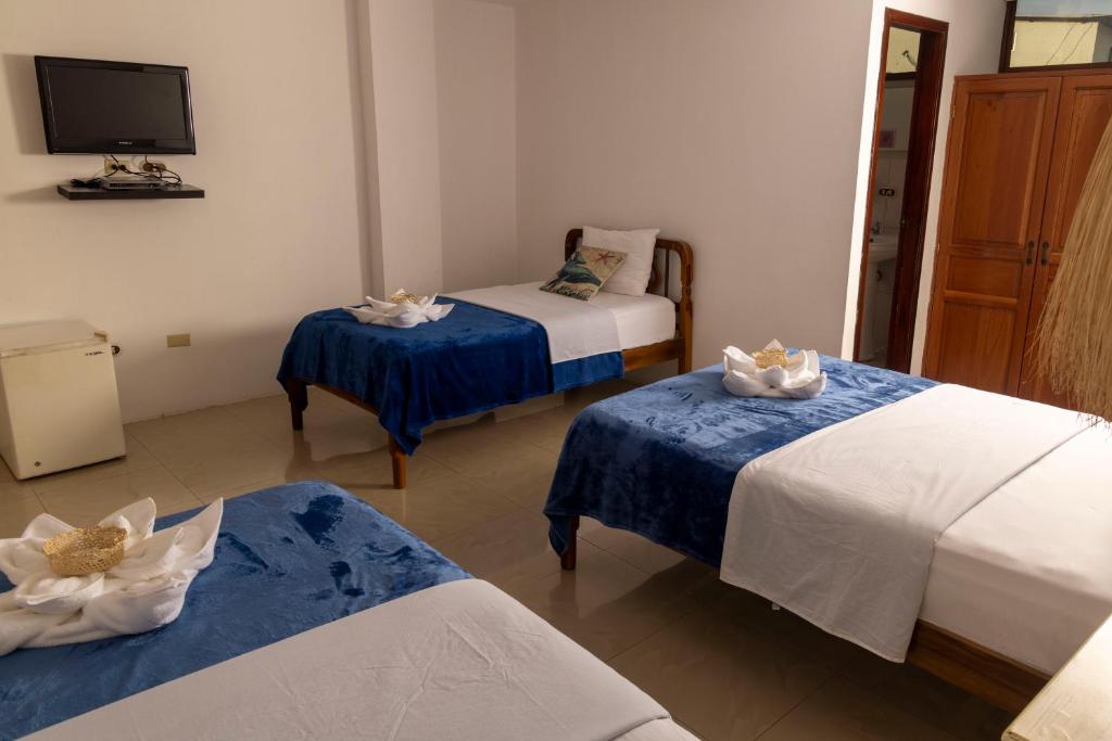 Postel nebo postele na pokoji v ubytování Galapagos Planet Hotel
