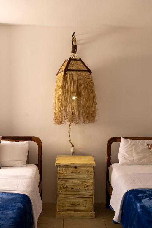 Postel nebo postele na pokoji v ubytování Galapagos Planet Hotel