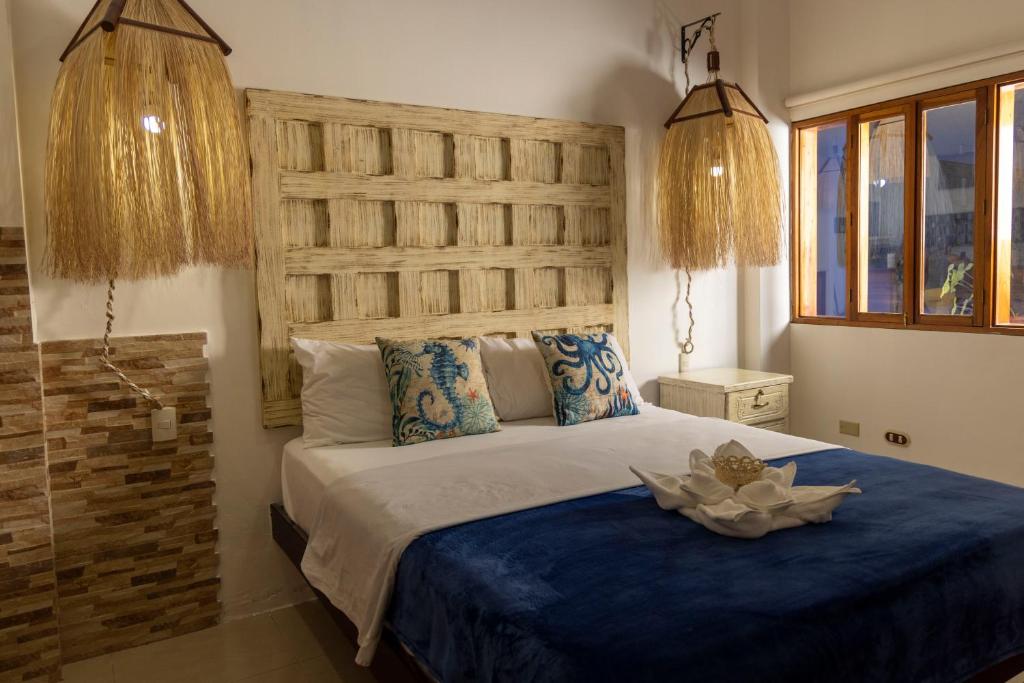 Postel nebo postele na pokoji v ubytování Galapagos Planet Hotel