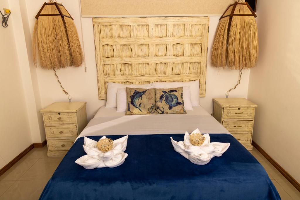 Postel nebo postele na pokoji v ubytování Galapagos Planet Hotel