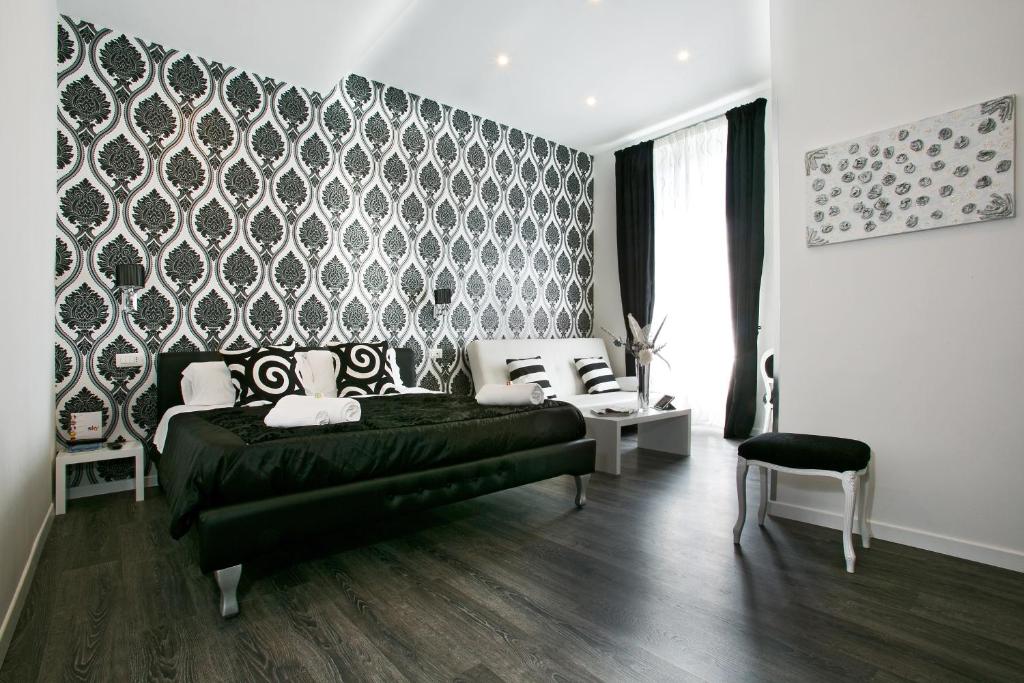 a bedroom with a black bed and a black and white wall at Rome Key Luxury House in Rome