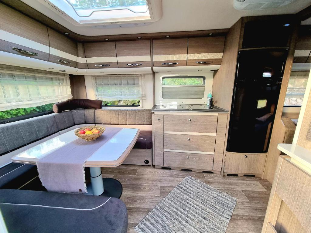 an interior view of an rv with a table in it at Kemping Stawy Marcowe w Głuszycy in Głuszyca