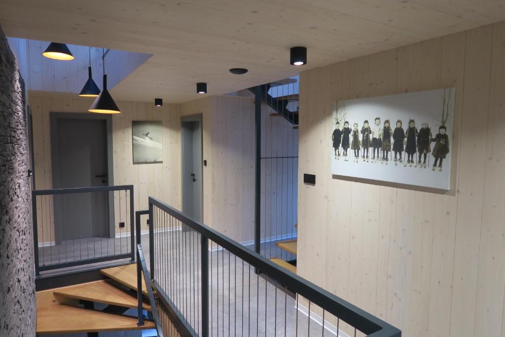 a hallway of a building with stairs and a picture on the wall at Chata Jestřábník in Dolní Morava