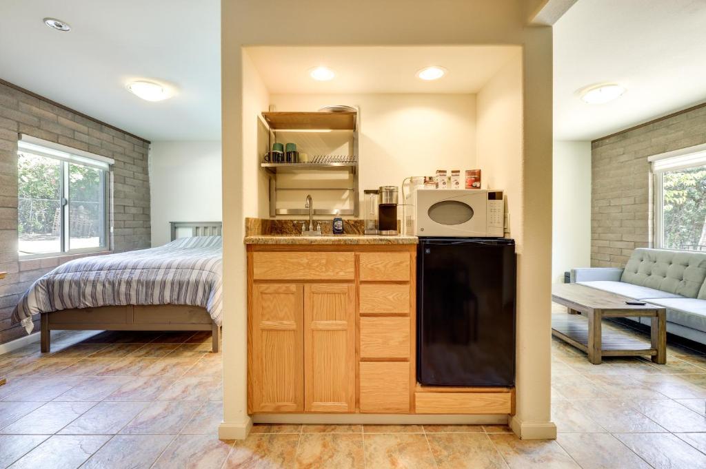 eine Küche mit einem Waschbecken und ein Bett in einem Zimmer in der Unterkunft Clear Lake Getaway with Pool Access, Near Beaches! in Clearlake Oaks