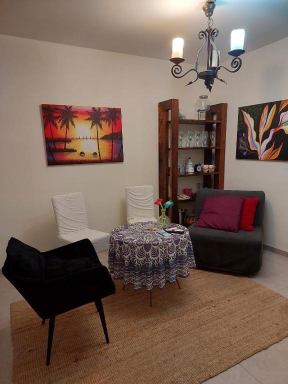 a living room with a table and a couch at Dudger apartment in Bet Shemuʼel