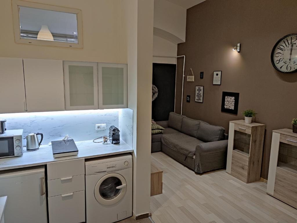 a kitchen and a living room with a washing machine at Smart Apartment 2 in Budapest