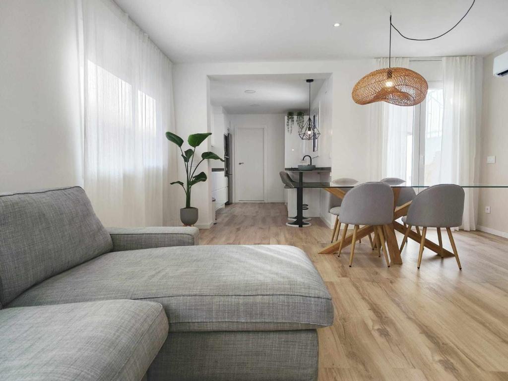 a living room with a couch and a table at Mazi Apartments Cuba in Mataró