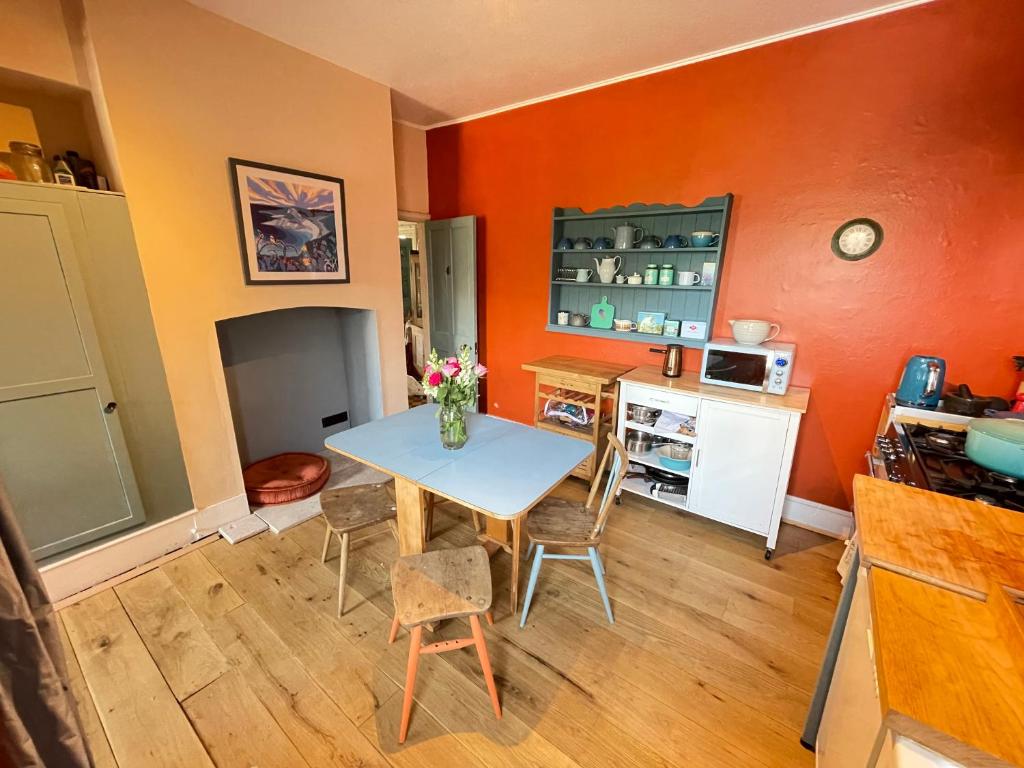 a kitchen with a table and chairs in a room at Maisonette - Halfway down to Swanage or up to Durlston in Swanage