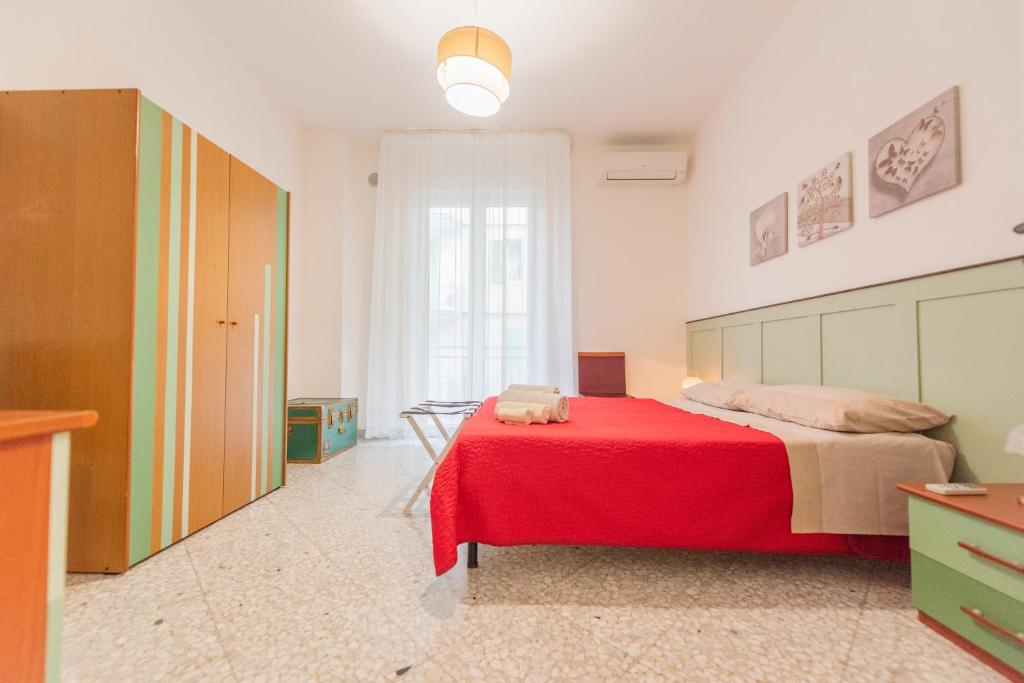 een slaapkamer met een rood bed in een kamer bij Casa Cicetta in Giovinazzo