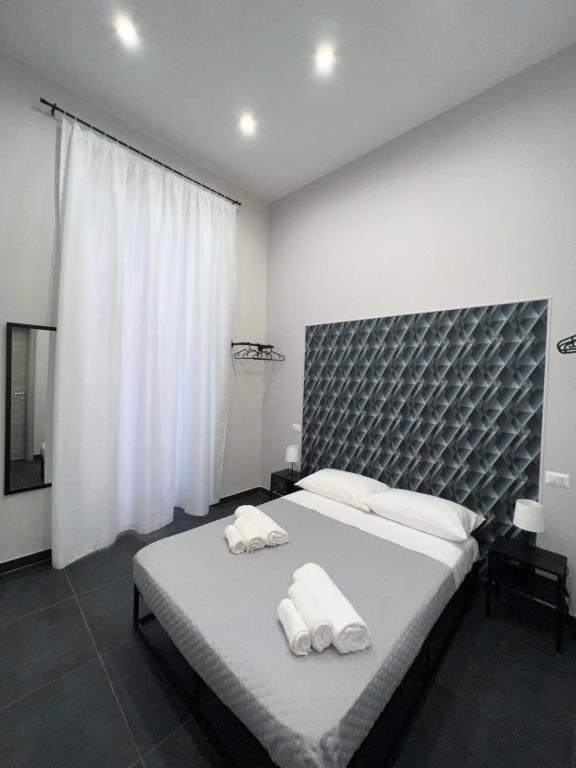 a bedroom with a large bed with two towels on it at Civico Sedici in Naples