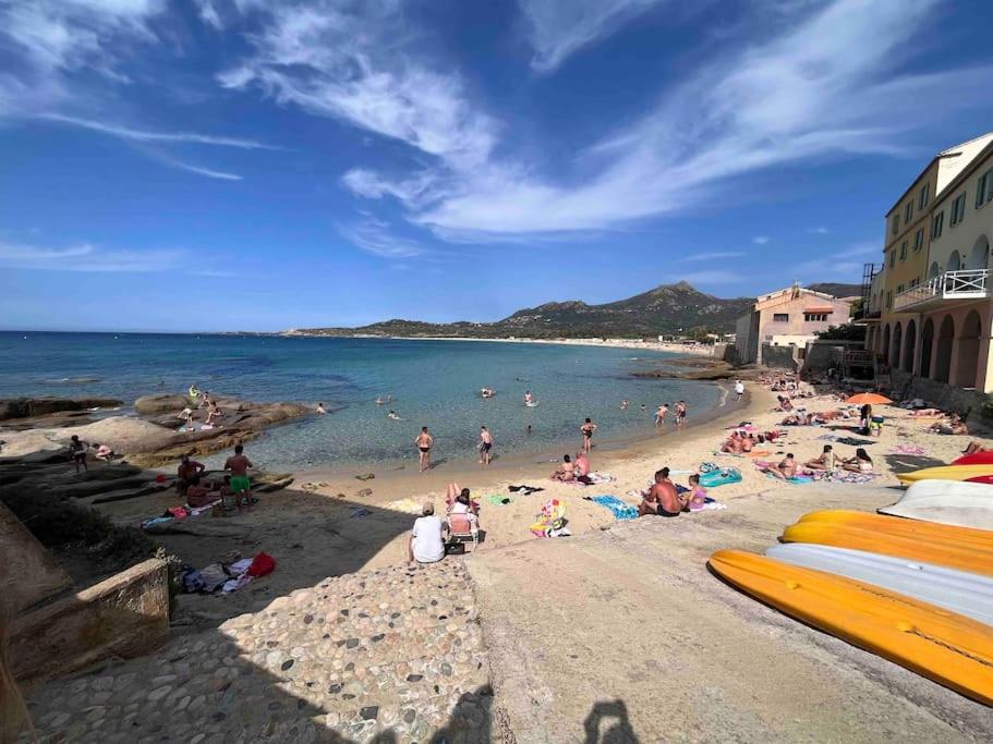 a group of people sitting on a beach at Casa Mariuccia in Algajola