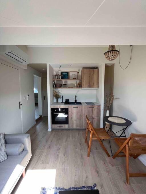 a living room with a couch and a kitchen at Casa Mariuccia in Algajola