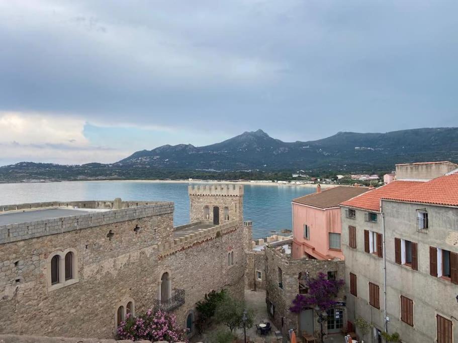 a view of a body of water and some buildings at Casa Mariuccia in Algajola