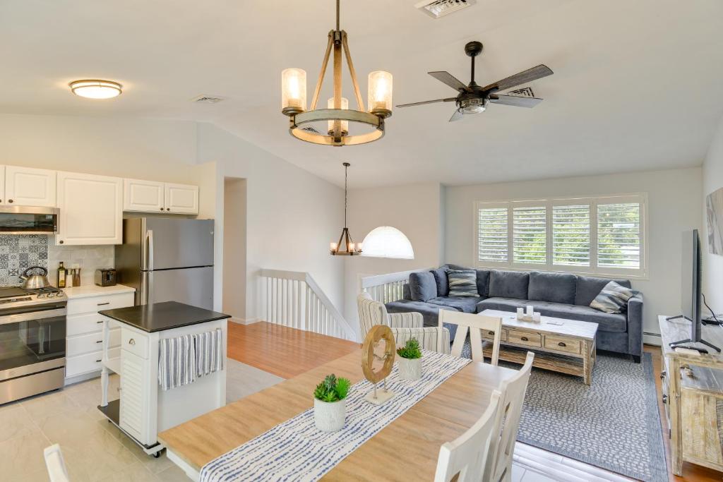 a kitchen and living room with a couch and a table at Narragansett Vacation Rental Near River and Beach! in Narragansett