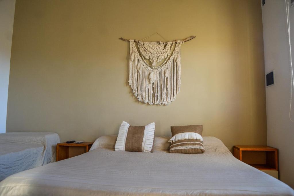 a bedroom with a bed with two pillows on it at La Justina - Alquiler Temporario in Cafayate