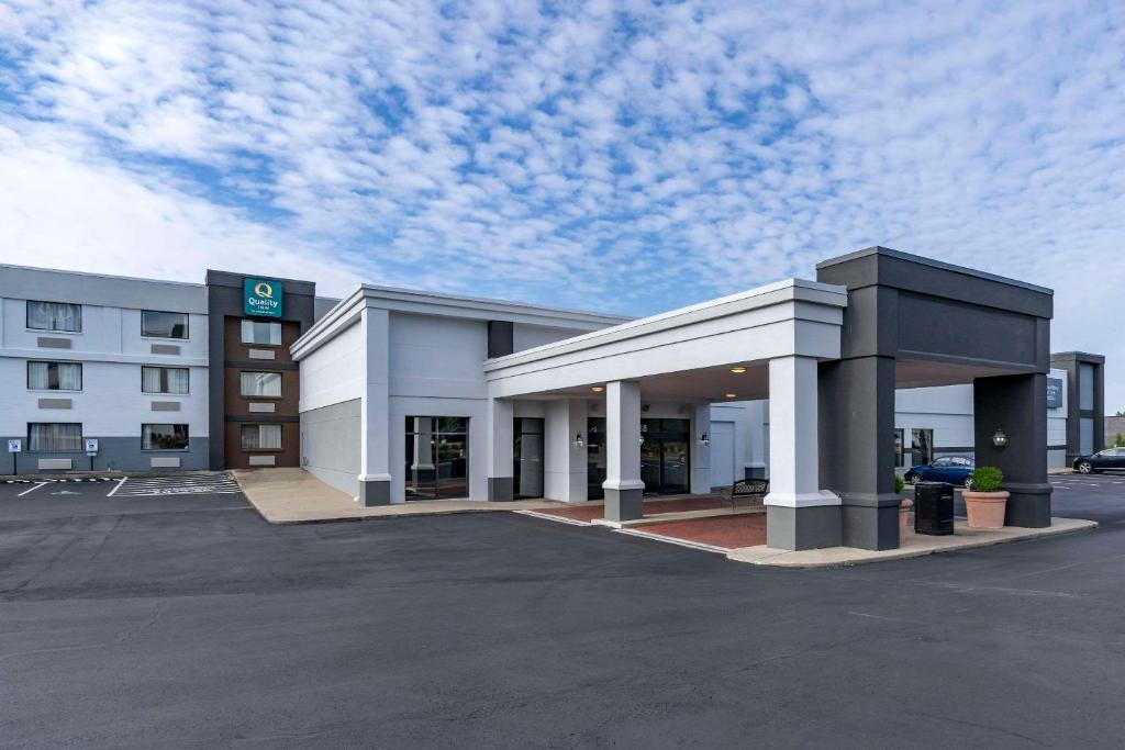 a building with a parking lot in front of it at Quality Inn Lexington -Horse Park in Lexington