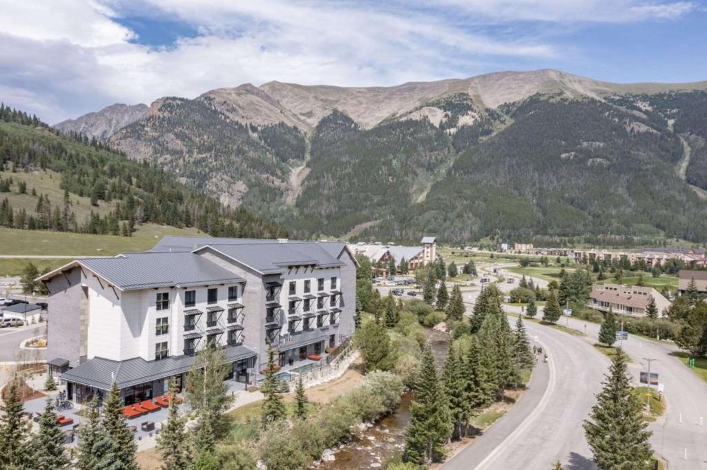 an aerial view of a building with mountains in the background at Cambria Hotel Copper Mountain in Frisco