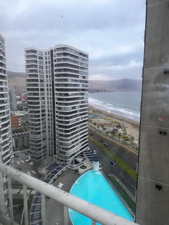 a view of the ocean from the balcony of a building at Departamento con vista al mar in Iquique