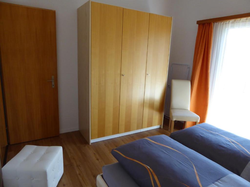 a bedroom with a bed and a wooden cabinet at Chalet Gerbera in Wengen