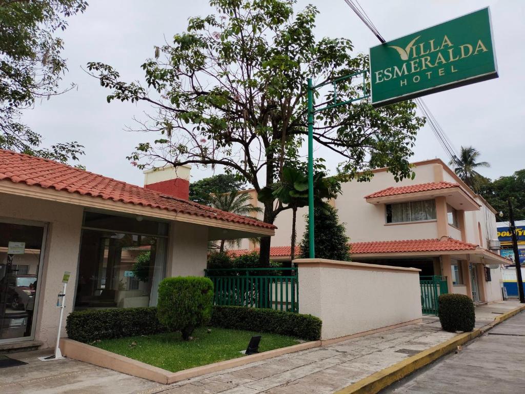 una señal frente a un edificio con un edificio en Villa Esmeralda, en San Juan Bautista Tuxtepec