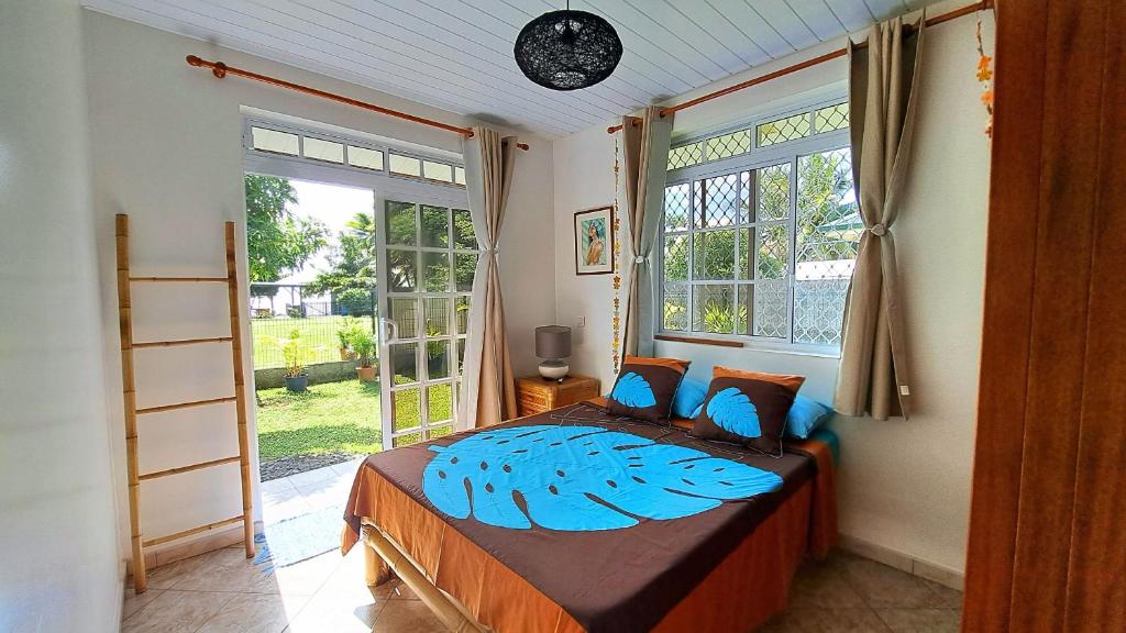 a bedroom with a bed and a large window at TAHITI - Motu Nono Beach View 