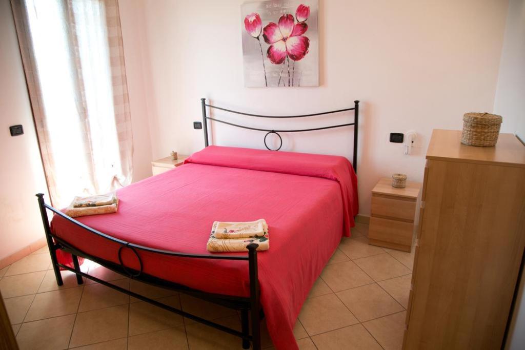 ein Schlafzimmer mit einem roten Bett mit einer roten Decke in der Unterkunft A Casitta a pochi km da Taormina in Calatabiano