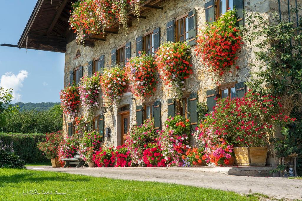 a building with flowers on the side of it at Bachtelhuber-Hof in Teisendorf
