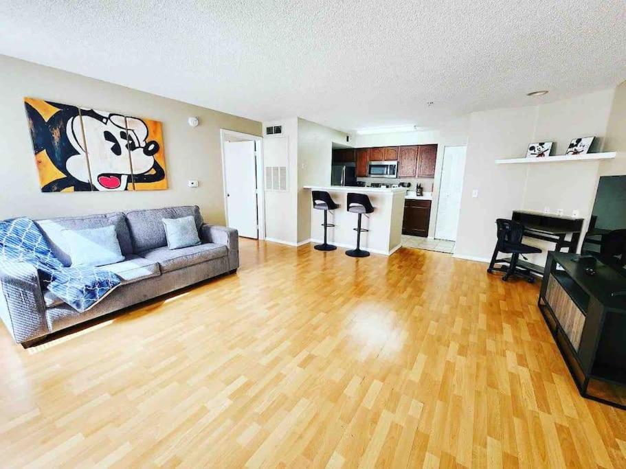 a living room with a couch and a piano at Cozy & spacious 2 BR / 2 BA condo in Kissimmee