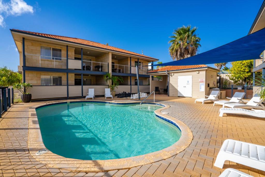 a swimming pool in front of a house at Kalbarri Edge Resort in Kalbarri