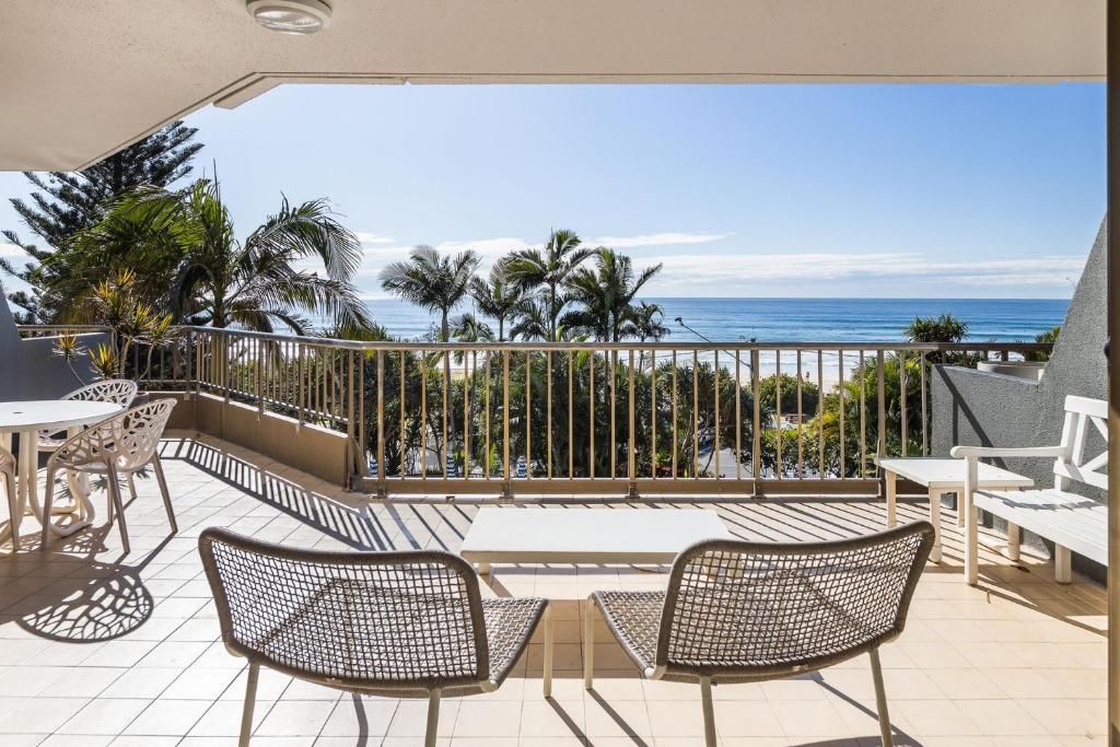 a balcony with a table and chairs and the ocean at The Rocks Resort Unit 3C in Gold Coast