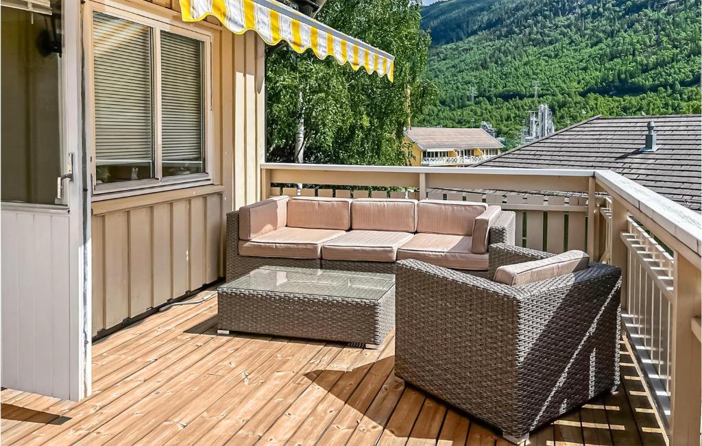 a patio with a couch and a table on a deck at 2 Bedroom Amazing Apartment In Rjukan in Rjukan