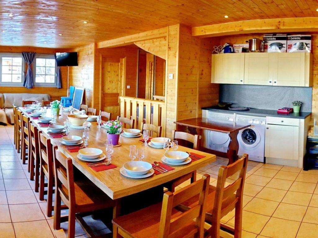 a dining room with a long table with chairs at Chalet Le Corbier, 8 pièces, 16 personnes - FR-1-267-257 in Villarembert