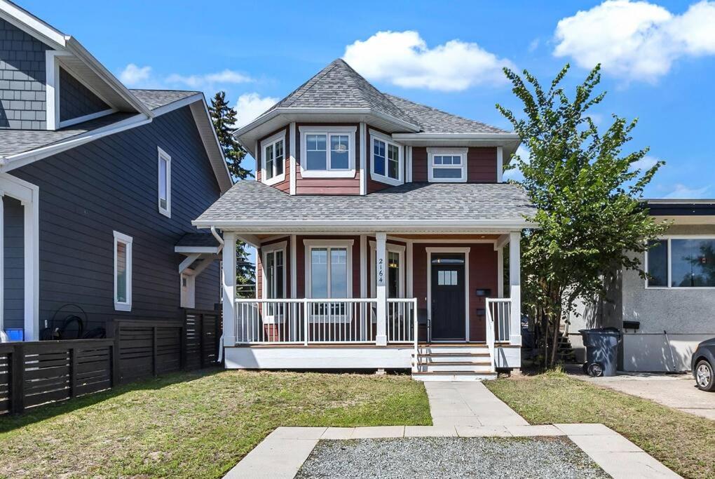 a house with a porch and a fence at Comfort and joy in Prince George