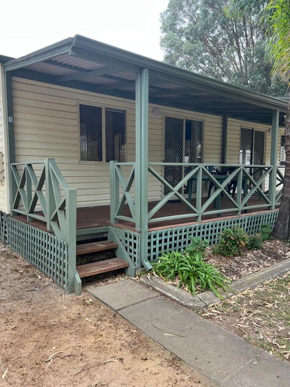 a screened porch on a house with a porch istg istg at Esperance Pink Lake Tourist Park in Esperance