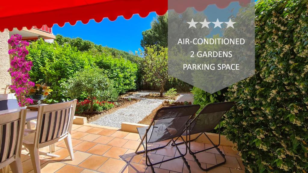 a patio with two chairs and a sign that reads art conditioned gardens parking space at Casalionelantibes Appartement de 70m2 avec jardins et parking in Antibes