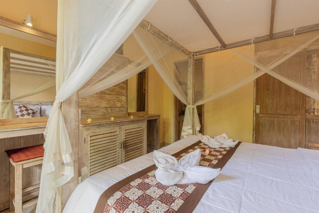 Postel nebo postele na pokoji v ubytování Alam Pracetha Bali Ubud