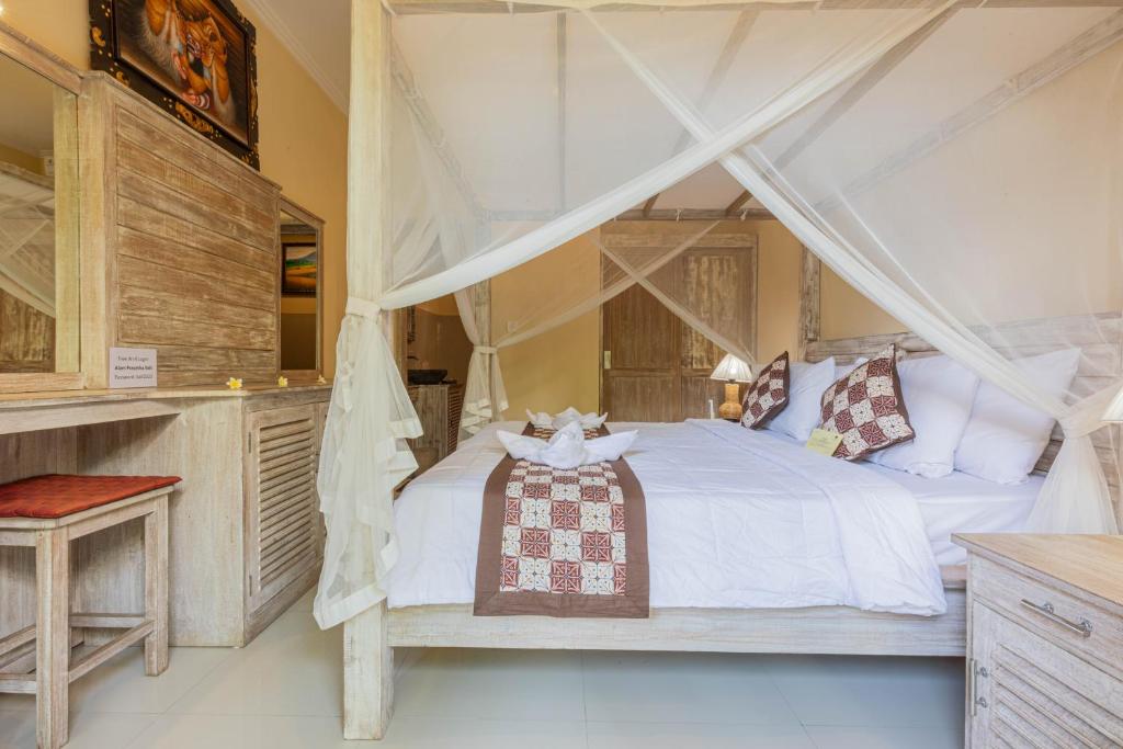 Postel nebo postele na pokoji v ubytování Alam Pracetha Bali Ubud