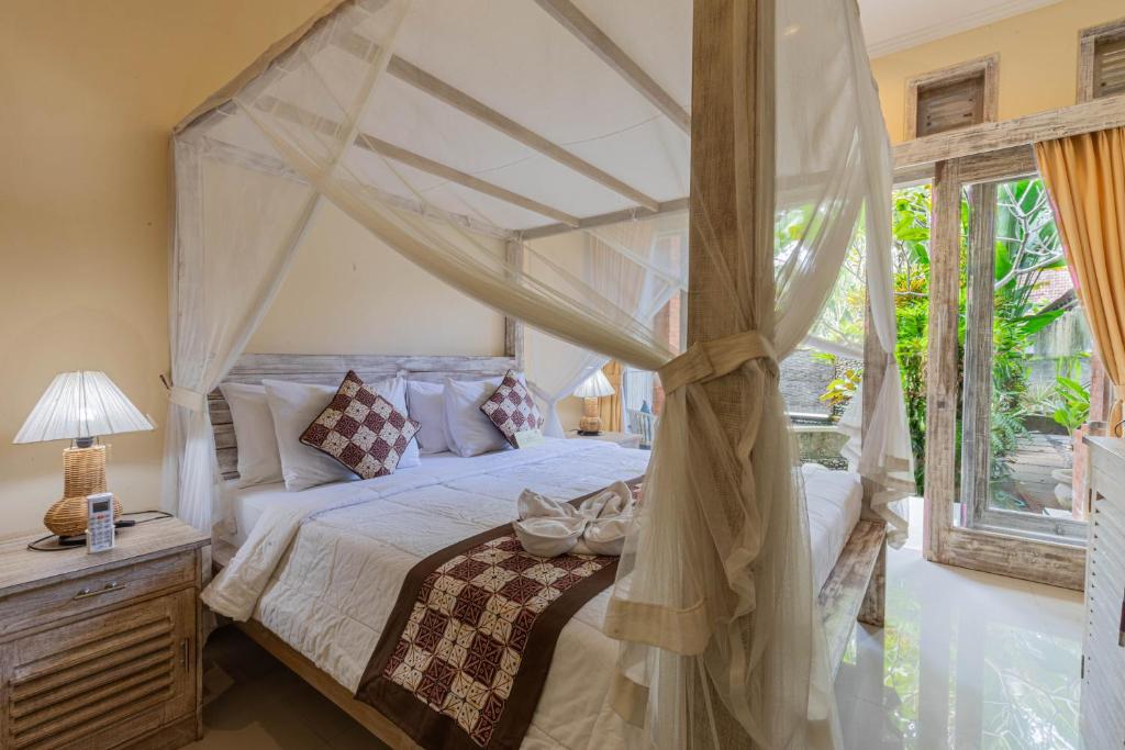 Postel nebo postele na pokoji v ubytování Alam Pracetha Bali Ubud
