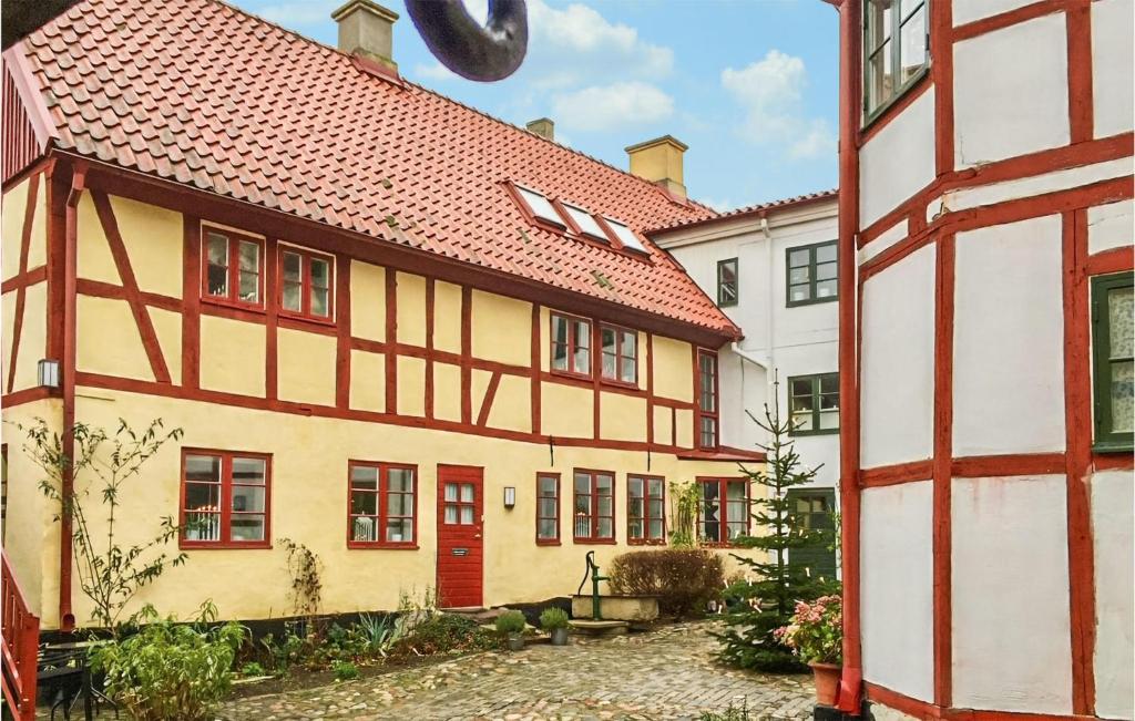 an old house with a red and white building at 2 Bedroom Amazing Apartment In Ystad in Ystad