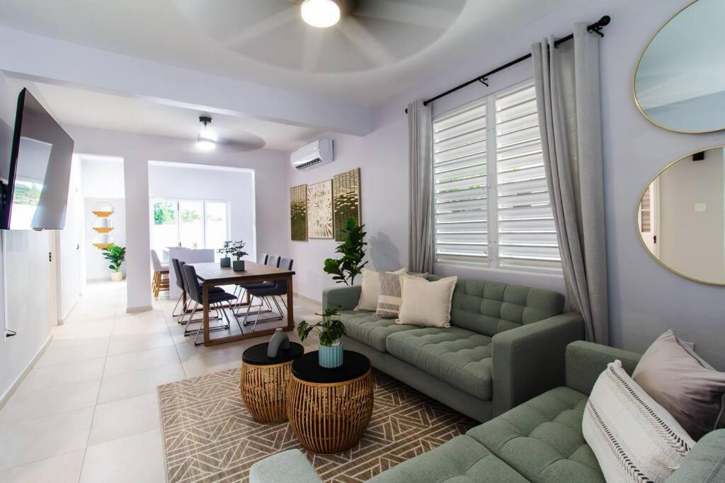 a living room with a couch and a table at Casa Marilina Aguadilla w/ Pool in Aguadilla